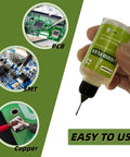 Hand holding Liquid Soldering Flux For Electronics Pro Grade No Clean Rosin Flux Dropper Bottle 30 mL with circuit boards