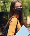 Woman outdoors wearing All Day Safe Kn95 Face Mask Pack Of 50 Individually Wrapped 5 Ply Breathable Filter Mask With 95 Percent Filtration