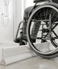 3.5 Inch High Collapsible Shower Threshold Water Dam, 59 Inch Long Splash Guard Barrier with wheelchair on tiled floor