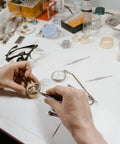 Hands using Stainless Steel Watch Spring Bar Pins And Repair Tool Kit For Watch Band Link Replacement on workbench