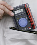 Person holding Card Size HiTester And Digital Multimeter With 41.99 Megaohms Resistance 500 Volts AC DC Range showing 419.9V reading.