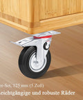 Close-up of a 4 Piece Caster Wheels Set for Furniture and Work Benches with 360 Swivel and Foot Brake Locks on wooden floor.