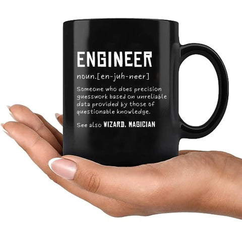 Engineer Definition Ceramic Mug 11 Oz Black Funny Gift For Engineering Students And Pros in hand with white text definition