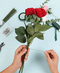 Person arranging flowers using DIY Floral Arrangement Kit With Green Floral Tape And Wire For Boutonniere And Bouquet