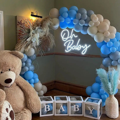 Neon Sign for Baby Shower Backdrop LED Light Up Wall Decor 21.5 Inch By 20 Inch Great for Gender Reveal Birthday Party Decorations Oh Baby Theme next to blue and white balloon arch with teddy bear.