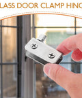 Close-up of stainless steel glass door hinge, 5 to 7mm thick, held in hand, suitable for shower doors and display cabinets