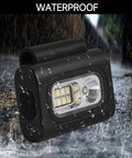 Clip On Running Light Two Pack Magnetic Clip On Light For Runners With Six Lighting Modes Rechargeable Reflective Night Running Gear For Walking Hiking Camping Black in rain showing waterproof feature.