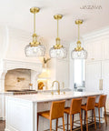 JAZAVA 10-Inch Brushed Gold Pendant Light, Modern Farmhouse Hanging Fixture above kitchen island with ribbed glass shades.