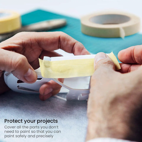 Person tearing a piece from the Six Roll Masking Tape Pack 0.75 Inch By 60 Yards Multi Surface Paper Tape For Painting Walls Glass And Sidewalk Chalk Art Delivers Clean Sharp Lines Leaves No Residue No Mess Easy Tear