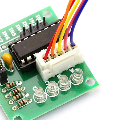 Close-up of 28BYJ-48 stepper motor driver board with ULN2003 on green PCB, white 5-pin header and color-coded wires
