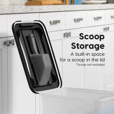 Two Pack Dog Food Storage Containers With Airtight Seal And Rolling Wheels Holds Up To 30 Lbs Each One Hand Open BPA Free Made In USA Clear And Black featuring lid with built-in scoop storage shown against a kitchen cabinet background.