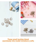 150 Pcs Mini Buckles Alloy Tiny Sewing Fasteners With Single Prong Quick Release For Doll Clothes Shoes Bags Belts Craft Diy Projects Mixed Silver Gunmetal Antique Finish displayed on crafting table with ribbons and beads in background.