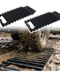 Heavy Duty 2 Pack Car Tire Traction Mats Featuring Non Slip Grip And Compact Handles Versatile Winter Recovery Tracks on muddy ground.