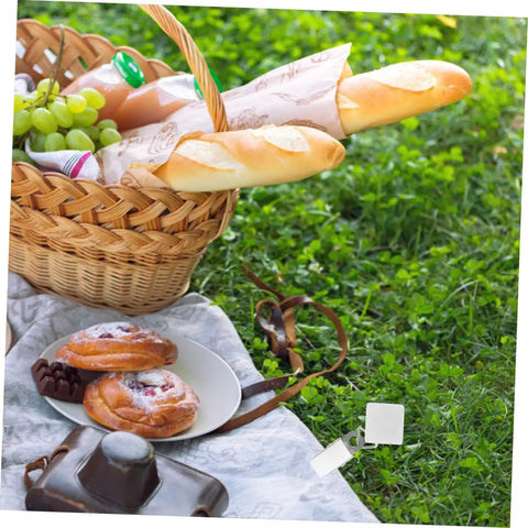 Picnic scene with Six Pieces Gold Rectangle Tablecloth Weights Clips For Outdoor Tables securing tablecloth in place