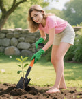 Kid using Kids Shovel For Sand And Snow, 28 Inch D Handle Metal Shovel With Fiberglass Handle in a garden setting, orange