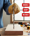 12-inch metal brad-point drill bit held by a gloved hand over a wooden workpiece; Baker and Bolt logo visible.