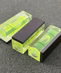 Three Six Pack Mini Magnetic Bubble Level Kit Sleek Acrylic Build With Neon Vials for precise measurements on surface.