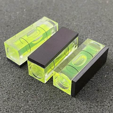 Three Six Pack Mini Magnetic Bubble Level Kit Sleek Acrylic Build With Neon Vials for precise measurements on surface.