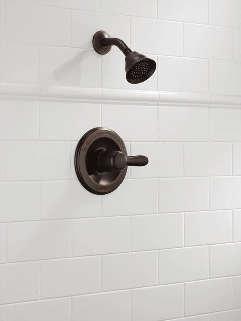 High End Lahara 14 Series Shower Trim Kit In Oil Rubbed Bronze with showerhead and control on white tile wall