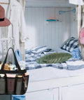 Odorless Mesh Shower Caddy With Dual Handles 8 Pocket Quick Dry Travel Organizer hanging in a dorm room.
