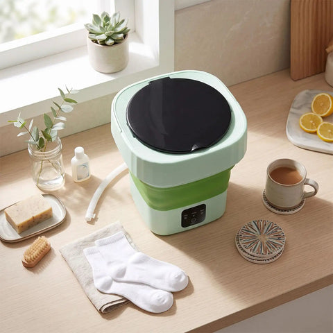 Laundry Day No Sweat With This 6L Folding Portable Washing Machine on a countertop with socks and detergent.