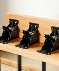 Three Piece Black Folding Table Braces With 180 Degree Self Lock Hinges mounted on wood for heavy duty stability.