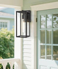 Outdoor Wall Lanterns 2 Pack, Anti Rust Exterior Sconce Lights For Front Door Mount with black metal frame next to blue door
