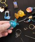 Dope Electric Jewelry Drill Kit with 74 Piece Set including mini hand drill, resin jewelry, keychains, and accessories shown up close