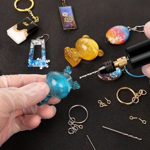Dope Electric Jewelry Drill Kit with 74 Piece Set including mini hand drill, resin jewelry, keychains, and accessories shown up close