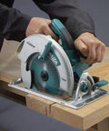 Professional 8 1 4 Inch Magnesium Circular Saw With Electric Brake cutting through wood with sawdust flying.