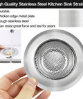 Hand holding stainless steel kitchen sink strainer, highlighting durable construction and thickened edge plate.