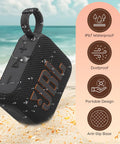 Go 4 Portable Bluetooth Speaker With IP67 Waterproof And Dustproof Build on a beach, black with carry loop