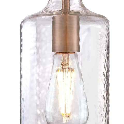 Close-up of Washed Copper Sleek One Light Mini Pendant With Clear Textured Glass Shade, showcasing light bulb and texture.