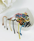 Assorted colorful beads chains in a bowl for crafts and keychain projects, similar to 50 Pcs 4 Inch Ball Beads Chain With Connectors.