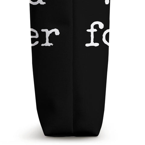 Side view of Work Hard Foil Harder Wing Foil Wingsurfing Tote Bag showcasing black fabric and white text detail.