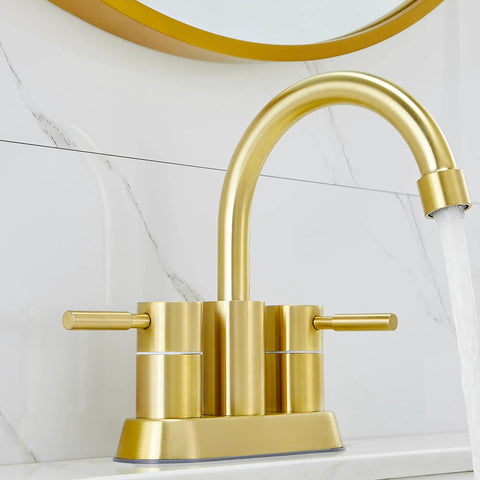 Gold Finish Bathroom Faucet With Dual Handles 360 Degree Rotating Stainless Steel Vanity Lavatory Sink Mixer Lead Free Modern Design Double Handle Commercial Style For Bathroom Sink Easy Operation And Clean Look installed on a white marble countertop