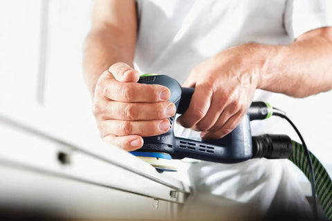 Three And A Half Inch Hard Pad For RO 90 DX Sander in use, showing edge sanding on narrow materials, ensuring crisp flat finish.