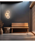 LMAPLUMP Wall Lamp Wall Sconce Modern Artistic Luxury Iron Textured Ripple Glass Light 3-Light Cluster LED illuminating a stylish entryway.