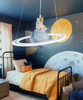 Space Themed Astronaut Pendant Light For Kids Room Dimmable Planet LED Chandelier With 3000K 4000K And 6000K Color Temperatures 19 Inch 40W hanging in a space-themed children's bedroom.