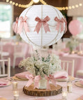 Six Pink Bow Hot Air Balloon Table Centerpieces Set With 9.8 Inch Paper Lanterns, Mini Woven Baskets, Wooden Sticks in event setting