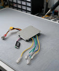 All-In-One Dual ESC Electric Skateboard Controller With Wireless Remote, 430W 12A, cables on desk in workshop