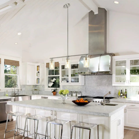 Three Light Pendant With Clear Glass Shades In Brushed Nickel for kitchen island, modern farmhouse style in bright kitchen setting.