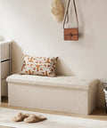 Foldable Storage Ottoman Bench With Padded Seat And Built In Chest in soft gray linen, placed in a bedroom setting.