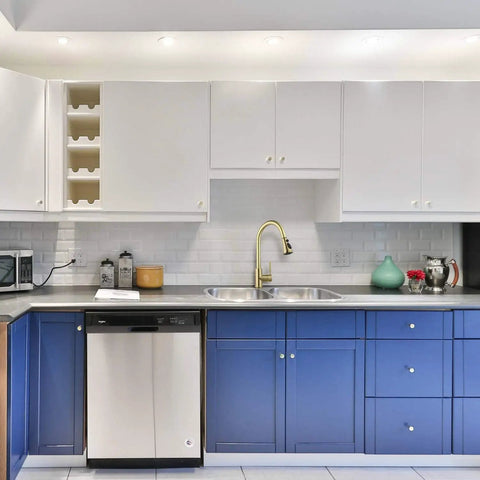 Gold Kitchen Faucet With Pull Out Sprayer, Single Handle in modern kitchen with white and blue cabinetry and stainless steel appliances