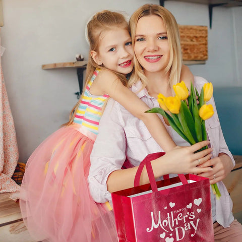 Mother and daughter celebrating with 2 Pack Mother's Day Gift Bags With Tissue Paper And Cards Reusable Nonwoven Gift Totes