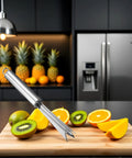 Pineapple Eye Remover Tool With V Shaped Stainless Steel Blade next to sliced fruits on a cutting board