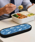 Blue Dinosaur Themed Portable Utensil Kit With Zipper Pouch next to lunchbox at workplace