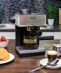 The Real Deal 4 Cup Steam Espresso System With Built In Frothing Arm For Rich Coffee And Creamy Lattes Easy Peasy Setup on kitchen counter.