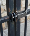 Heavy Duty 4 Pack Weld On Spring Gate Latches No Nonsense Outdoor Fence Hardware on a metal gate with rust.