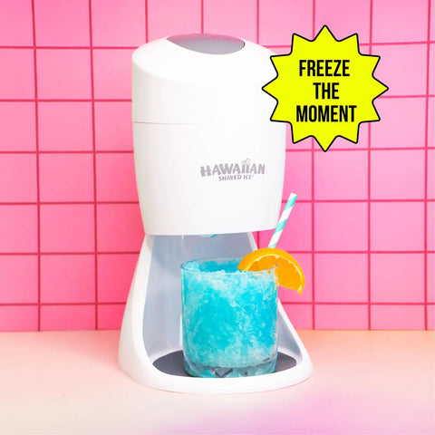 Electric Shaved Ice Machine Kit With Bold Syrup Blends And Twenty Slurp Season Cups creating blue slush in kitchen setting.